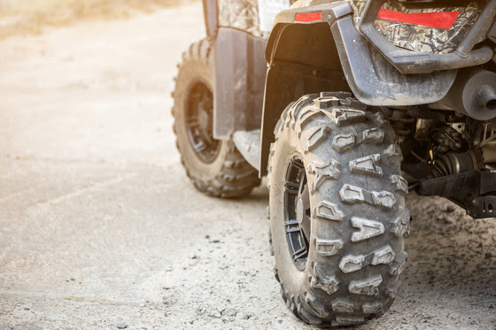 Close up of muddy ATV wheel