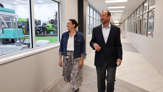 An image of a two people walking in a building.