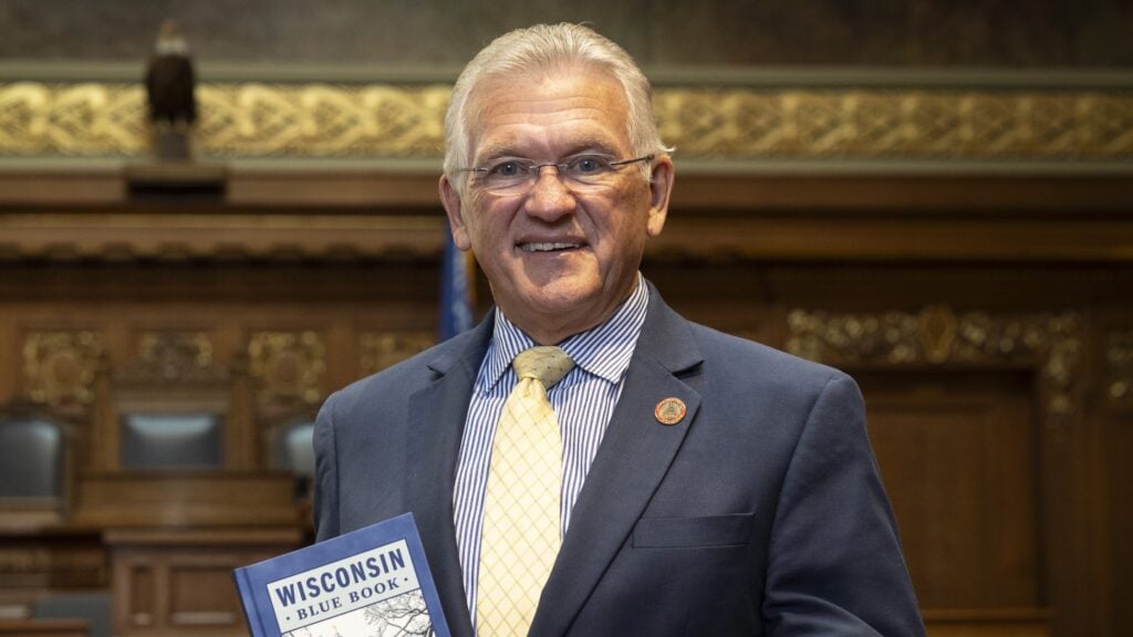 Photo of Rep. Jerry O'Connor hodling a Wisconsin Blue Book.