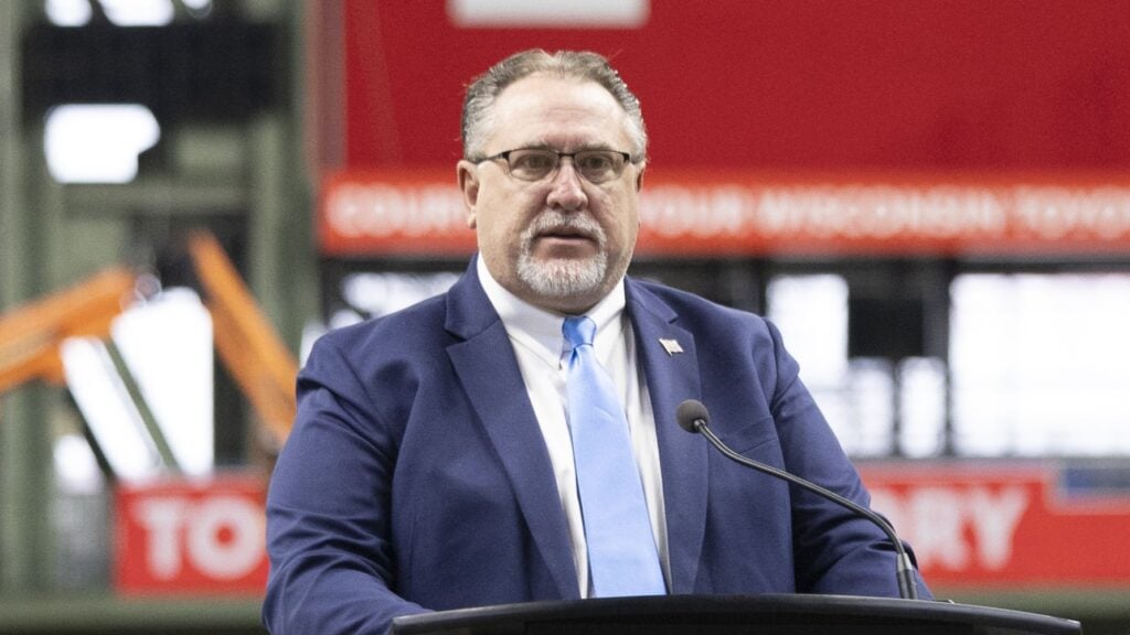 Photo of Rep. Rob Books at a podium at American Family Field in Milwaukee.