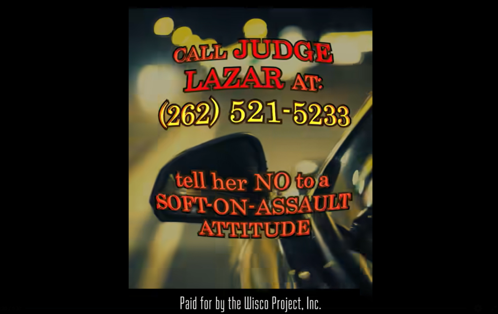 A screenshot of an ad targeting Supreme Court candidate Maria Lazar. Text above stock footage of a car shot from outside the driver's side window implores viewers to call Lazar and "tell her NO to a SOFT-ON-ASSAULT ATTITUDE."