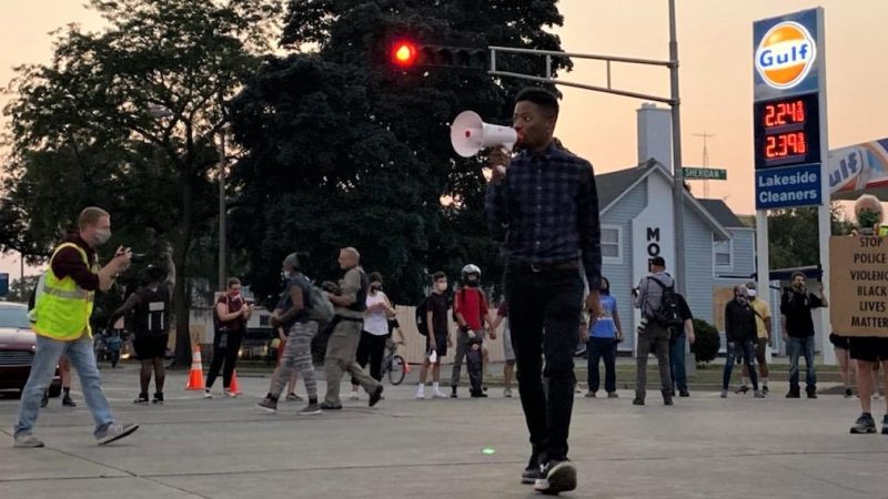 A small crowd gathers in Kenosha at the beginning of a fourth night of protests in response to the officer-involved shooting of Jacob Blake. Photo by Adam Kelnhofer.