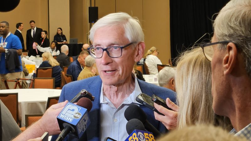 Gov. Tony Evers takes questions from reporters at a Wisconsin delegation breakfast at the August 2024 Democratic National Convention in Chicago. Photo by David Wise, State Affairs Pro-Wisconsin/WisPolitics.