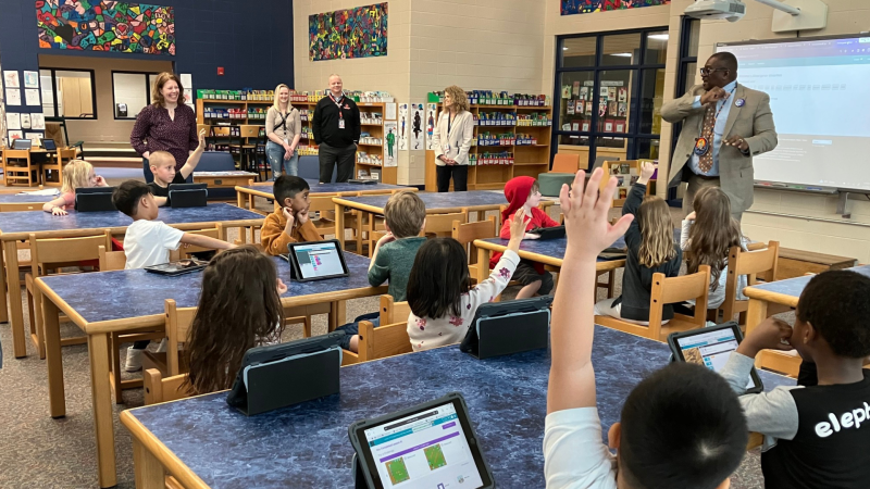 Darrell Williams, assistant state superintendent for the Division for Libraries and Technology (right), addresses students at Horizon Elementary in Sun Prairie. Department of Public Instruction photo.