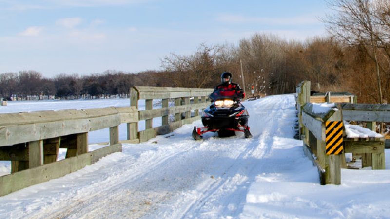 Snowmobiling on Rock Lake Bridge.
